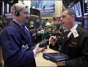 Stocks struggled Monday but ended up slightly on the New York Stock Exchange.