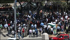 Workers and resident gather at the Angel de la Independencia square after evacuating buildings during a 7.9 earthquake in Mexico City.