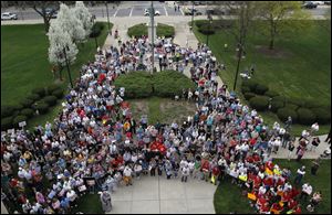 The gathering on the Lucas County Courthouse lawn was one of many across the country at the noon hour Friday.