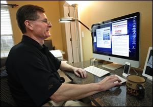 Eric Russell, 52, holder of an engineering degree from UT, pursues his job search from the command center he set up in his Sylvania home. He recently completed a master’s degree in organizational development from BGSU.