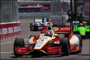 Helio Castroneves leads during the IndyCar Series' Honda Grand Prix auto race in St. Petersburg, Fla.