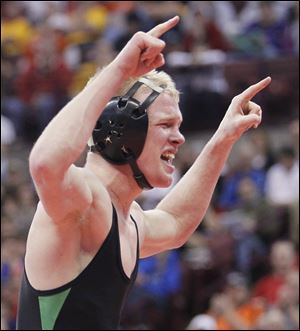 Delta’s Luke Kern celebrates his victory in the Division III state final at 138 pounds.