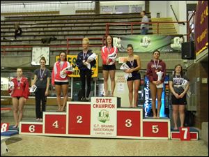 Wauseon’s Kendall Weber stands on the top spot of the podium after winning the Division II state diving championship. She is joined by Lake’s Samantha TenEyck (third), Wauseon’s Lacy Mynhier (fourth), and Genoa’s Baily Dipman (fifth).