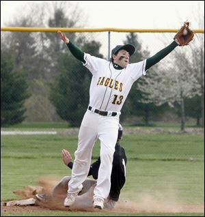 Clay High School's second baseman Matt York reaches for the ball while Perrysburg High School's  Seth Durham steals second base.