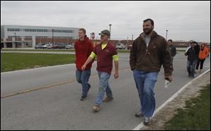 Jason Vida, right, who teaches construction at Penta Career Center, walks with some of his students Friday as part of the school’s Relay for Life. 
