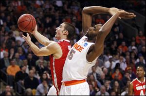 Ohio State guard Aaron Craft (4) drives past Syracuse forward Rakeem Christmas (25) during Saturday's game.