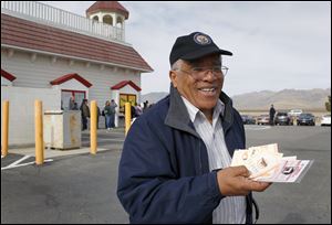 Reinaldo Nunley holds his Mega Millions lottery tickets outside the Primm Valley Lotto Store at Primm, Calif., on Thursday, March 29, 2012. Nunley said he bought 56 tickets because 56 is a lucky number for him. With a half-billion-dollar multistate lottery jackpot up for grabs, Nevadans are waiting up to four hours in line to get their Mega Millions tickets. 