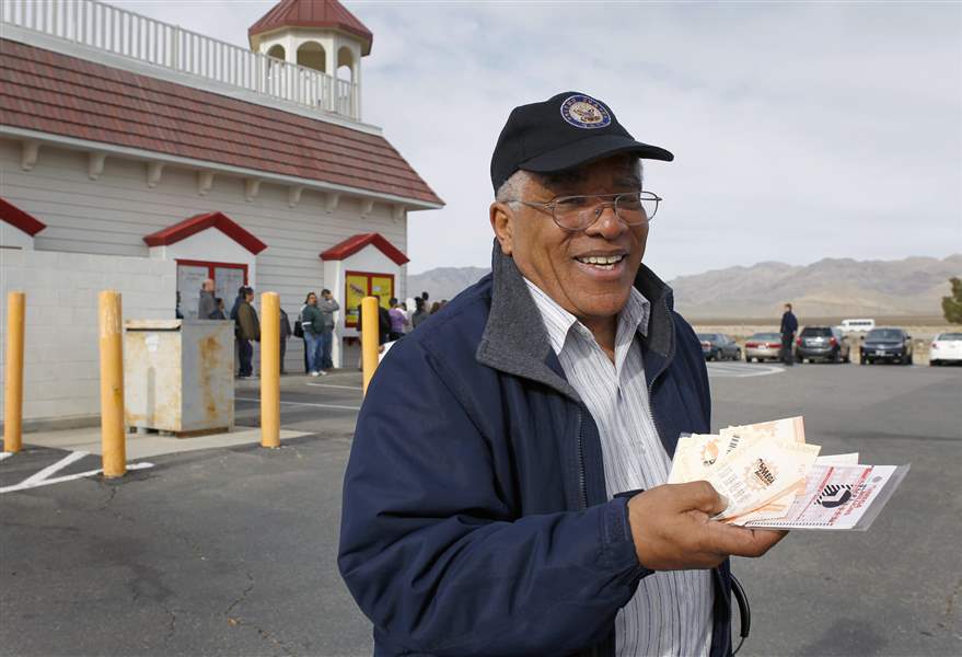 Reinaldo-Nunley-holds-his-Mega-Millions-lottery-tickets-outside-the-Primm-Valley-Lotto-Store