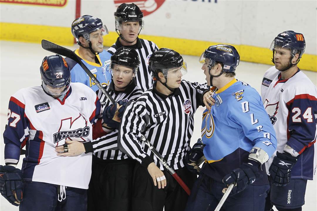 Referees-separate-Walleye-s-Riley-Emmerson-27-and-Kalamazoo-s-Darrly-Bootland-27