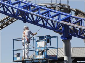 The Millennium Force gets some new paint. A string of unseasonably warm days has helped maintenance workers get a jump-start on sprucing up the park before it opens on May 12.