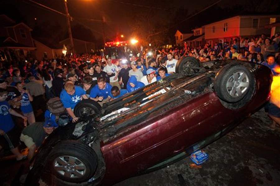 Raucous fans burn couches, flip cars in the streets after Ky.’s Final