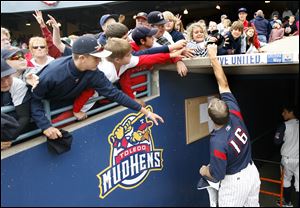 Mud Hens catcher Max St-Pierre gives his cap to a fan as he leaves the dugout. In the first 10 seasons there were 297 sellouts, an average of almost 30 per year among the 72 home games.