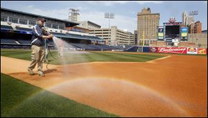Jake Tyler, sports turf manager for the Toledo Mud Hens, works on getting Fifth Third Field ready for Wednesday's noon game.