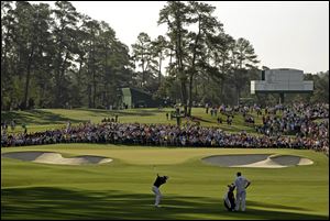 Adam Scott, of Australia, hits to the second green Thursday during the first round the Masters golf tournament in Augusta, Ga.