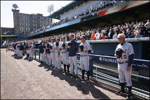 The Detroit Tigers, with manager Jim Leyland, right, stand during the national anthem before Wednesday's game at Fifth Third Field.