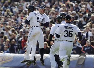 The Detroit Tigers rush to congratulate Austin Jackson, left, after his bases-loaded game-winning single in the ninth inning of a baseball game against the Boston Red Sox in Detroit. Detroit won 3-2.