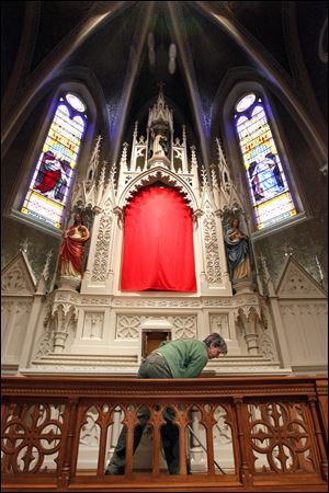 Volunteer Mary Adamiak sweeps the floors on the altar at St. Rose. She was one of more than 30 people who brought their own cleaning supplies Wednesday to spruce up the church two days after a steeple fire caused by lightning. The church's cross fell 170 and crushed a copper gutter. Other damage includes a short circuit in the system that rings the bells.