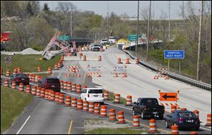 Traffic is rerouted for construction on the I-475 bridge over the Maumee River near Maumee. The work, which was begun last summer, resumed in March.