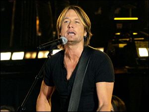 Singer Keith Urban performs during the 45th Annual CMA Awards in Nashville, Tenn.  Urban  emerged from his surgery to remove a polyp and a nodule from his vocal cords with benefits he never imagined.