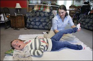 Brianna Burkett of Gibsonburg works with physical therapy assistant Rebecca BeVier.