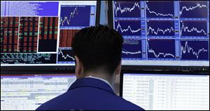 A specialist works at his post on the floor of the New York Stock Exchange.