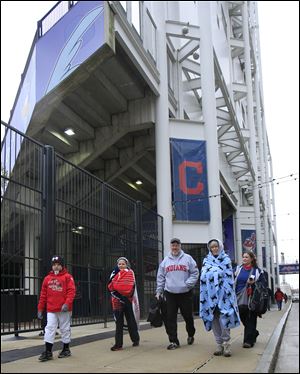 Grant, left to right, and Anna Craig, Rob and Pat Rose and Mickey Craig walk past Progressive Field all bundled up.