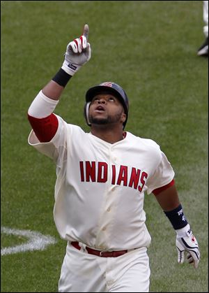 Cleveland Indians' Carlos Santana points skyward Sunday as he heads home after hitting a two-run home run in the fifth inning against the Toronto Blue Jays.