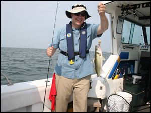 David Mustine, former ODNR director, displays a Lake Erie walleye he caught aboard Sea Breeze Sixteen last summer during the 33rd annual Governor's Fish Ohio Day promotion at Port Clinton. 
