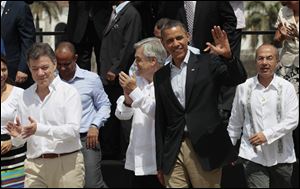 President Obama waves after the official photo at the Summit of the Americas in Colombia. Applauding at left is Colombia’s president, Juan Manuel Santos; left of Mr. Obama is Chile’s president, Sebastian Pinera, and at right is Mexico’s Felipe Calderon.