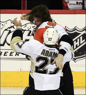 Philadelphia’s Scott Hartnell winds up as he and Pittsburgh’s Craig Adams battle during one of many simultaneous third-period fights.
