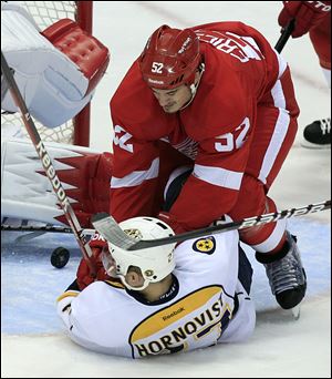 Detroit Red Wings defenseman Jonathan Ericsson (52) checks Nashville Predators right wing Patric Hornqvist (27) during the second period of Game 3.