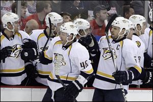 Andrei Kostitsyn (46) and defenseman Shea Weber (6) celebrate with the Predators’ bench after Weber’s goal during the first period.
