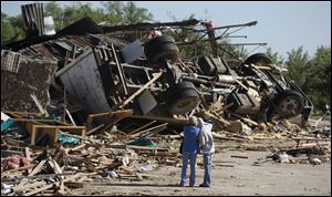 An overturned tractor-trailer rig is crushed into the rubble of a business in Woodward, Okla. The tornado that hit the city was the only one to cause fatalities. Forecasters warned for days about threats to life.