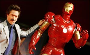 In this 2008 file photo,  U.S. actor Robert Downey Jr. poses with a life-size 