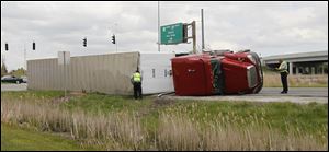 An overturned tractor trailer blocks the on ramp to southbound I-75 in Perrysburg on Monday after a single vehicle accident. 