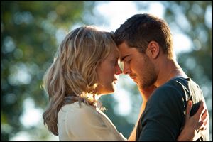 Taylor Schilling, left, and Zac Efron play Beth and Logan in 'The Lucky One.'