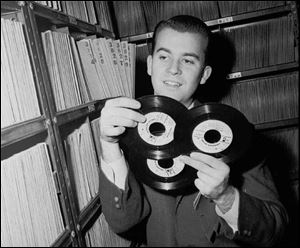In this Feb. 3, 1959 file photo, Dick Clark selects a record in his station library in Philadelphia.