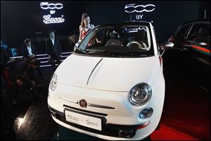 A Fiat 500 co-designed by the Italian fashion house Gucci is among the vehicles on display in Beijing that have been crafted with Chinese buyers in mind. Automakers are trying to overcome a sales slump in the world's largest automobile market.