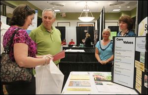 Tracey Haynes of Maumee, left, questions representatives of Sunshine Inc. of Northwest Ohio about job openings with the nonprofit Thursday at the 2012 Career Expo in Perrysburg.