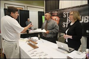 Tim Martin of Delta, left, discusses what opportunities he might have at Republic Steel of Lorain, Ohio, with Republic representatives Jim Hardy, center, and Debbie Sayre. The Blade sponsored the job fair.