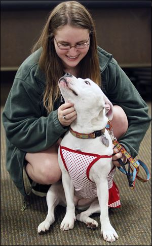 Maddie Keating, 16, of Sylvania plays with her pit bull Wendy at Wednesday night's forum.