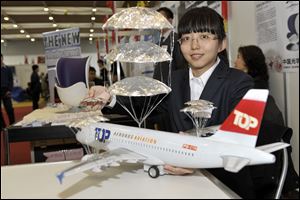 Yu Gao of China presents her invention -- an emergency landing system for airplanes -- at the 40th International Exhibition of Inventions, New Techniques, and Products in Geneva. 