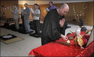 Jay 'Rinsen' Weik leads a service at the Toledo Zen Center in Holland.  The center is changing its name to better reflect its growth as a spiritual home for Buddhism as well as to address confusion about what Zen is. 