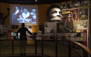 Ben Physick of Austrailia watches the life of Muhammad Ali in video clips on display at the Muhammad Ali Center in Louisville, Ky. 