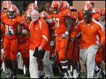  Blade sports writer John Wagner leads the Orange team onto the field at Doyt Perry Stadium for the Falcons' spring football game on April 13.