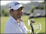  Ben Curtis holds his trophy after winning the the Texas Open golf tournament.