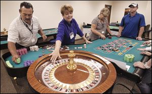 From left, Dan Sanders, Ruth Patterson, Barb Jones, and Mark Gruhlke practice roulette during training at Hollywood Casino Toledo. Dealers must record 16 hours of training a month at the casual sessions.
