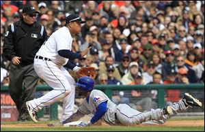 Texas Rangers' Elvis Andrus, right, safely slides into third base as Detroit Tigers third baseman Miguel Cabrera, center, waits for the throw from the outfield during the eighth inning of a baseball game in Detroit Sunday. Andrus scored on a sacrifice hit by teammate Josh Hamilton.