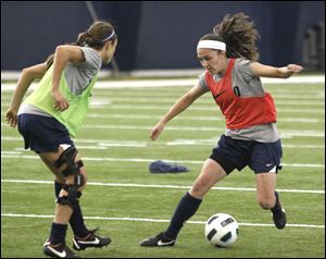 UT women’s soccer player Natalia Gaitan controls the ball against Jaime Morsillo in practice. Gaitan will compete on the Colombian soccer team in London.