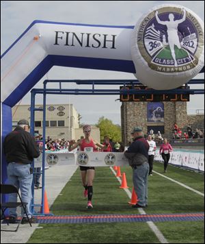 Jessica Odorcic of Madison, Ohio, in the northeast corner of the state, crosses the finish line first in the women’s division. Her winning time was 2 hours, 51 minutes, 52 seconds. The Glass City win was her first marathon.